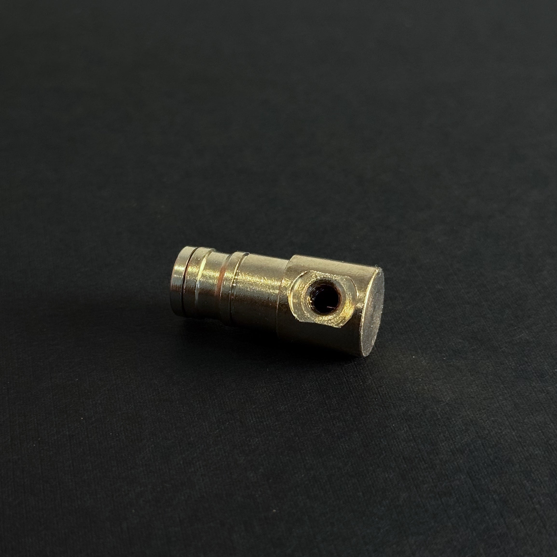 A quick connect end cap for a high pressure misting system with a single port for a misting nozzle on a dark 