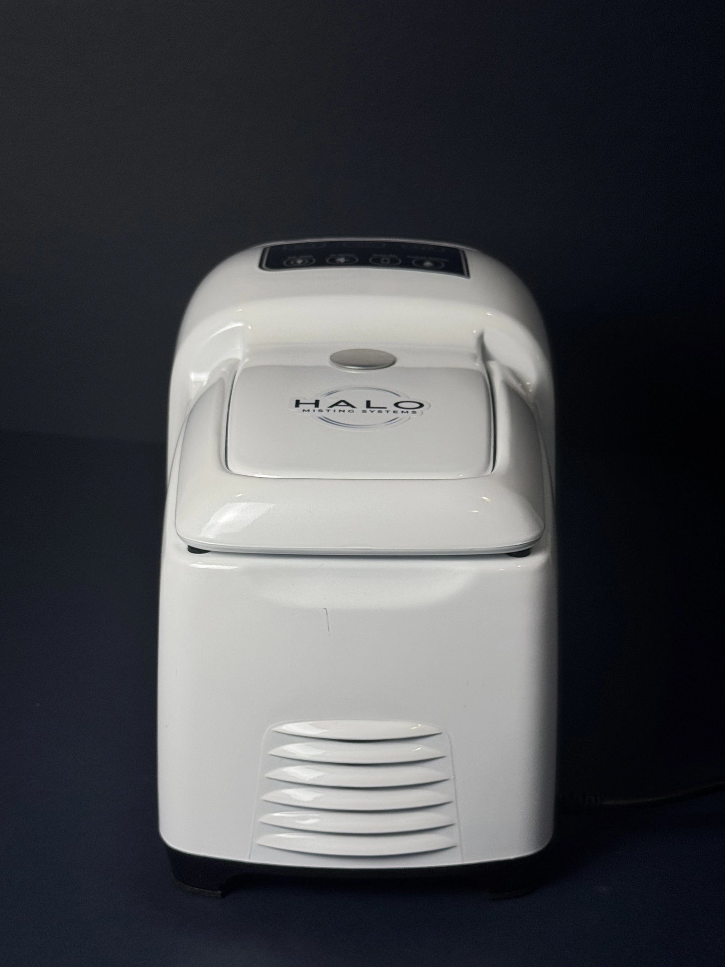 A rear view of a high pressure 1000 PSI misting pump with the word halo visible on top